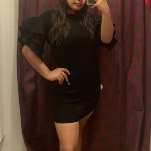 a black dress w shoulder flaps